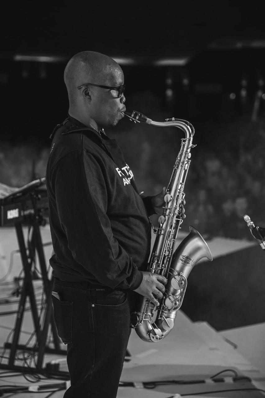 Black-and-white side view of the saxophonist performing